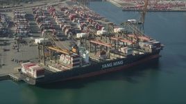 4.8K aerial stock footage approach and flyby a cargo ship being unloaded at the Port of Los Angeles, California Aerial Stock Footage | AX68_167