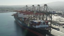 4.8K aerial stock footage orbit cranes unloading a cargo ship at the Port of Los Angeles, California Aerial Stock Footage | AX68_169