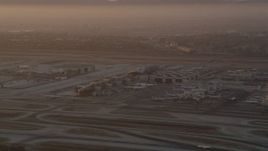 4.8K aerial stock footage of terminals, hangars and airliners at LAX at sunset, Los Angeles, California Aerial Stock Footage | AX69_006