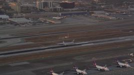 4.8K aerial stock footage track American Airlines passenger jet landing at LAX at sunset, Los Angeles, California Aerial Stock Footage | AX69_011