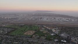 4.8K aerial stock footage pan across Los Angeles International Airport at sunset in California Aerial Stock Footage | AX69_018