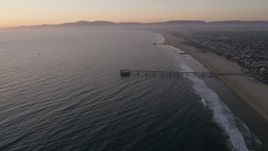 4.8K aerial stock footage approach the Venice Fishing Pier on the coast at sunset, California Aerial Stock Footage | AX69_024