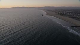4.8K aerial stock footage tilt to reveal Venice Fishing Pier and empty beach to Santa Monica at sunset, California Aerial Stock Footage | AX69_025