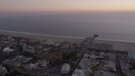 4.8K aerial stock footage flyby beachside buildings and Santa Monica Pier at twilight, California Aerial Stock Footage | AX69_038
