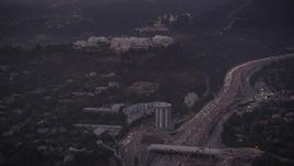 4.8K aerial stock footage of J. Paul Getty Museum, Hotel Angeleno, and I-405 with heavy traffic at twilight, Brentwood, California Aerial Stock Footage | AX69_054