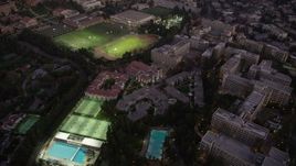 4.8K aerial stock footage orbit of campus buildings and sports fields at twilight at College, Westwood, California Aerial Stock Footage | AX69_056