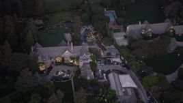 4.8K aerial stock footage of circling The Playboy Mansion and grounds at twilight, Los Angeles, California Aerial Stock Footage | AX69_065