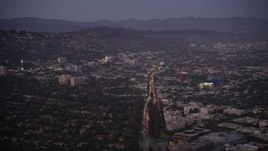 4.8K aerial stock footage of Santa Monica Boulevard through West Hollywood at twilight, California Aerial Stock Footage | AX69_068