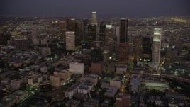 4.8K aerial stock footage tilt from urban apartment buildings to reveal and approach Downtown Los Angeles at night, California Aerial Stock Footage | AX69_080
