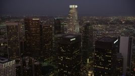 4.8K aerial stock footage fly over Paul Hastings Tower to approach US Bank Tower in Downtown Los Angeles, California at night Aerial Stock Footage | AX69_082