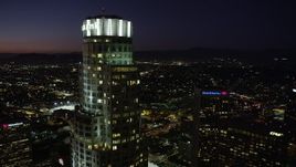4.8K aerial stock footage of orbiting the top of US Bank Tower in Downtown Los Angeles at night, California Aerial Stock Footage | AX69_116