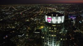 4.8K aerial stock footage orbit of the top of US Bank Tower in Downtown Los Angeles at night, California Aerial Stock Footage | AX69_118