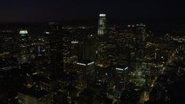 4.8K aerial stock footage of a view of US Bank Tower and skyscrapers in Downtown Los Angeles, California at night Aerial Stock Footage | AX69_129