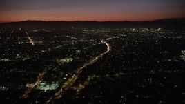 4.8K aerial stock footage of heavy traffic on Highway 101 and East Hollywood neighborhoods at night, California Aerial Stock Footage | AX69_134