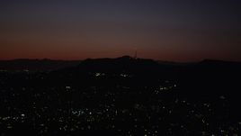 4.8K aerial stock footage of radio tower and the lights of homes atop the Hollywood Hills at night, California Aerial Stock Footage | AX69_135