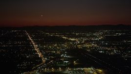4.8K aerial stock footage of runways at Burbank Airport and suburban neighborhoods at night, California Aerial Stock Footage | AX69_145
