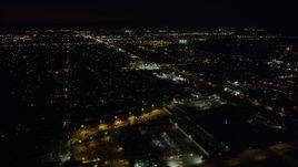 4.8K aerial stock footage tilt to reveal suburban Pacoima neighborhoods and Whiteman Airport at night, California Aerial Stock Footage | AX69_153