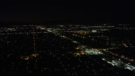 4.8K aerial stock footage fly over neighborhoods and pan to Whitman Airport in Pacoima at night, California Aerial Stock Footage | AX69_154