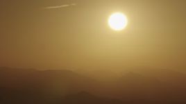 4K aerial stock footage The sun rising over the mountains Aerial Stock Footage | AX70_003