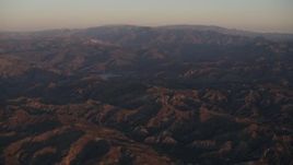 4K aerial stock footage Fly over Los Padres National Forest to approach a lake at sunrise, California Aerial Stock Footage | AX70_005