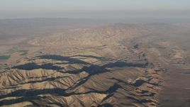 4K aerial stock footage Flyby mountain ridges at sunrise, Cuyama, California Aerial Stock Footage | AX70_031