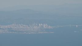 4K aerial stock footage Downtown San Francisco and the Bay Bridge as a commercial jet flies over city, California Aerial Stock Footage | AX70_092