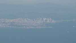 4K aerial stock footage Downtown San Francisco, the Bay Bridge as a jet airliner passes, California Aerial Stock Footage | AX70_094