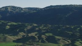 4K aerial stock footage Flyby green hills and mountains in springtime, Gilroy, California Aerial Stock Footage | AX70_101
