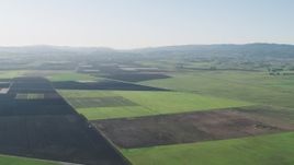 4K aerial stock footage Flying over large crop fields to approach Bolsa Road in Hollister, California Aerial Stock Footage | AX70_106