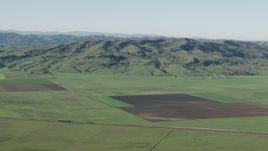 4K aerial stock footage of farm fields and hills in Hollister, California Aerial Stock Footage | AX70_107