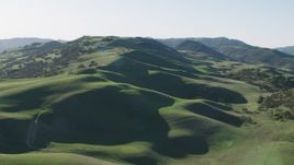 4K aerial stock footage A view of green hills with trees in Paicines, California Aerial Stock Footage | AX70_141