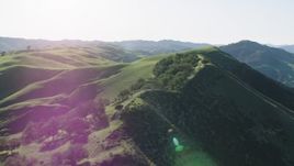 4K aerial stock footage Passing tall hills in Paicines, California Aerial Stock Footage | AX70_155