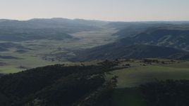 4K aerial stock footage of A valley surrounded by green hills in San Benito County, California Aerial Stock Footage | AX70_171