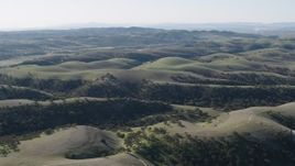4K aerial stock footage Dirt roads crossing over hills in San Benito County, California Aerial Stock Footage | AX70_178