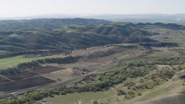 4K aerial stock footage An approach to small farms and green hills in San Benito County, California Aerial Stock Footage | AX70_182