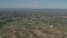 4K aerial stock footage Passing rural homes, vineyards, and a pond in Paso Robles, California Aerial Stock Footage | AX70_224
