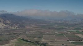 4K aerial stock footage Approaching a cloud over farm fields in Greenfield, California Aerial Stock Footage | AX70_242