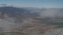4K aerial stock footage Fly through a cloud to reveal farm fields in Greenfield, California Aerial Stock Footage | AX70_245