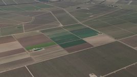 4K aerial stock footage Flyby crop fields by country roads in Soledad, California Aerial Stock Footage | AX70_251