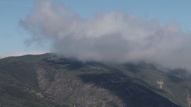 4K aerial stock footage of A cloud over a Santa Lucia Range mountain in California Aerial Stock Footage | AX70_256