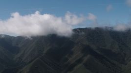 4K aerial stock footage of clouds over a Santa Lucia Range mountain ridge in California Aerial Stock Footage | AX70_269