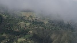4K aerial stock footage of misty clouds over green slopes in the Santa Lucia Range in California Aerial Stock Footage | AX70_277