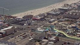 5.1K aerial stock footage orbiting Breakwater Beach Waterpark and Casino Pier, Seaside Heights, Jersey Shore, New Jersey Aerial Stock Footage | AX71_098E