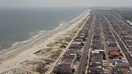 5.1K aerial stock footage of sunbathers on the beach and oceanfront homes in Ocean City, New Jersey Aerial Stock Footage | AX71_230