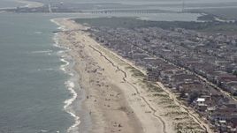 5.1K aerial stock footage of sunbathers enjoying the beach near oceanfront homes in Ocean City, New Jersey Aerial Stock Footage | AX71_231