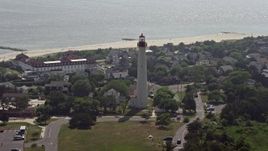 5.1K aerial stock footage of Cape May Lighthouse and coastal neighborhoods by the beach, New Jersey Aerial Stock Footage | AX72_010