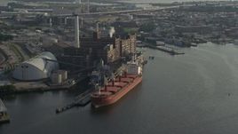 5.1K aerial stock footage of a cargo ship docked by the Domino Sugar Factory, Baltimore, Maryland Aerial Stock Footage | AX73_101