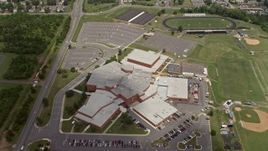 4.8K aerial stock footage tilting to Bird's Eye of High School in Manassas, Virginia Aerial Stock Footage | AX74_006