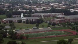 4.8K aerial stock footage of Charles Young Elementary School beside a high school football field in Washington D.C. Aerial Stock Footage | AX74_048
