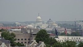 4.8K aerial stock footage of the United States Capitol seen over Smithsonian Museum domes in Washington DC Aerial Stock Footage | AX74_077E